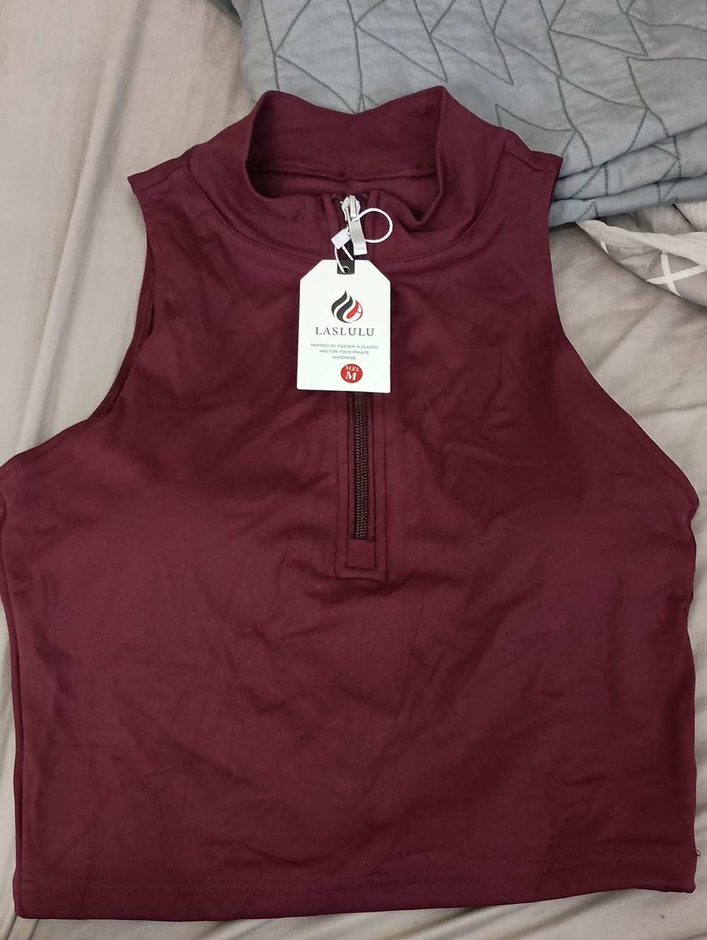 LASLULU brand sleeveless mock neck top featuring a front zipper in a deep red co